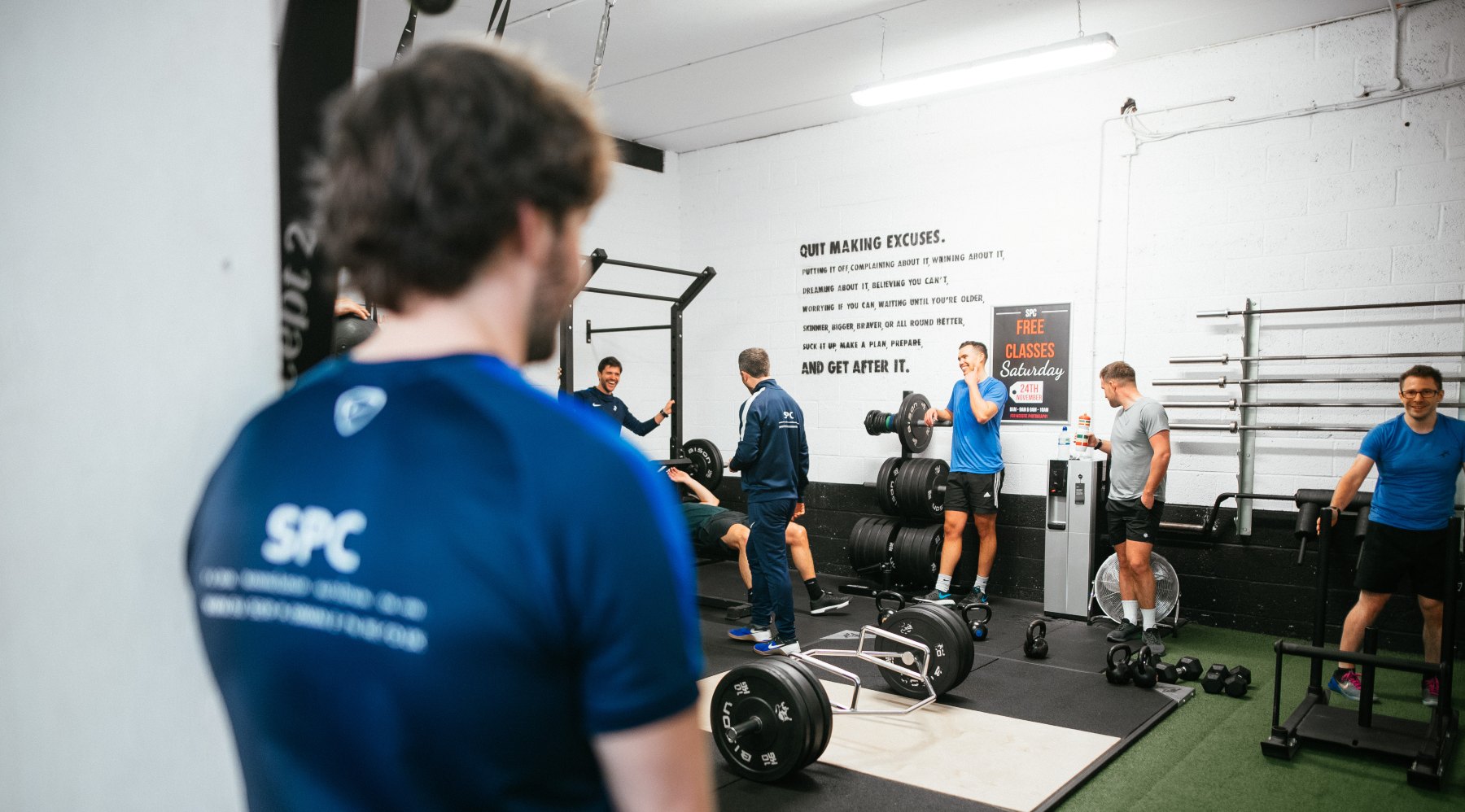 The gym floor at Sussex Performance Centre, Worthing, with the 'Quit making excuses' wall